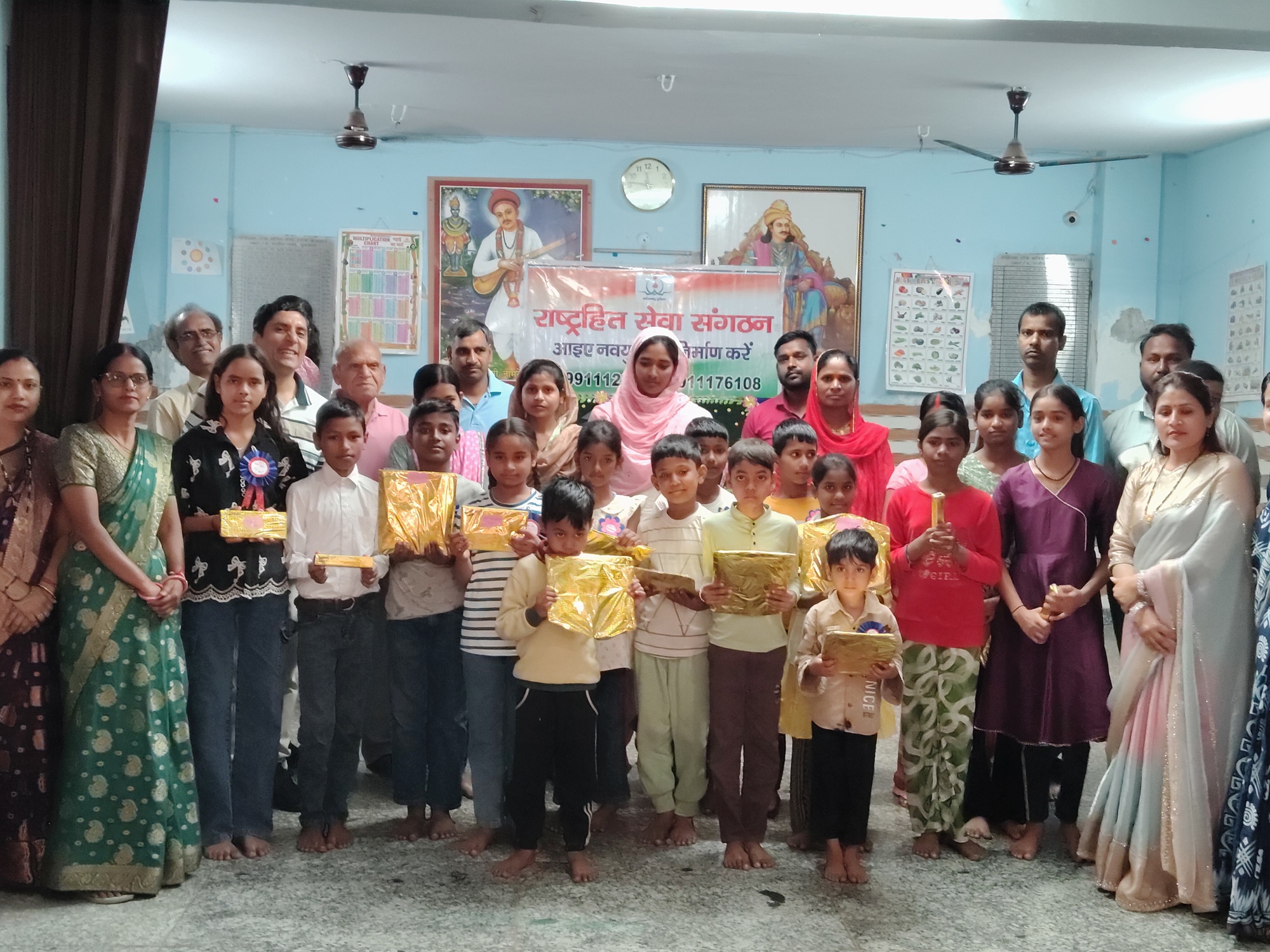Children receiving learning material at the RHSS Rajiv Nagar centre
